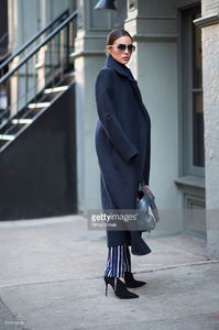 olivia-culpo-is-wearing-a-coat-from-ports-1961-stripe-pants-from-picture-id510113608.jpg