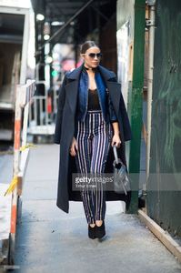 olivia-culpo-is-wearing-a-coat-from-ports-1961-stripe-pants-from-picture-id510113634.jpg