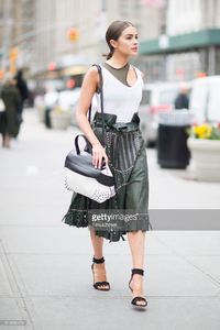 olivia-culpo-is-wearing-tods-skirt-and-bag-jbrand-tshirt-unravel-bra-picture-id519456478.jpg