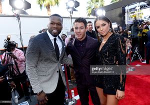 rapper-50-cent-recording-artist-nick-jonas-and-actress-olivia-culpo-picture-id473806294.jpg
