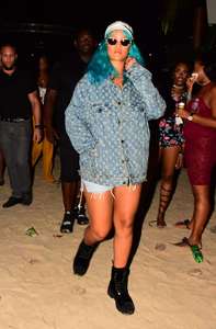 Rihanna--Wearing-a-turquoise-wig-at-a-carnival-event--03.jpg
