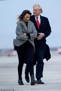 20928816-7678729-Bitter_cold_Trump_put_his_arm_around_his_wife_Melania_49_to_help-a-5_1573599632366.jpg