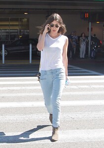 Lizzy-Caplan-in-Jeans-at-LAX--26.jpg