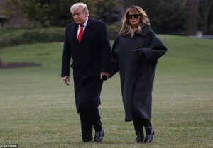 37465556-9103081-President_Donald_Trump_and_first_lady_Melania_Trump_walk_from_Ma-a-10_1609453415445.jpeg