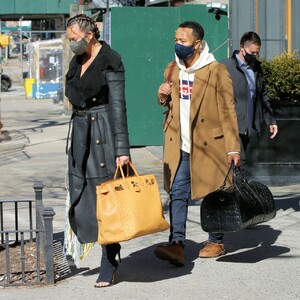 chrissy-teigen-in-a-full-length-black-leather-coat-and-open-toe-high-heels-ny-03-07-2021-0.jpg