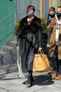 chrissy-teigen-in-a-full-length-black-leather-coat-and-open-toe-high-heels-ny-03-07-2021-1.jpg