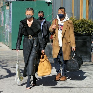 chrissy-teigen-in-a-full-length-black-leather-coat-and-open-toe-high-heels-ny-03-07-2021-2.jpg
