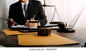 business-lawyers-discussing-contract-papers-260nw-1922827997.jpg