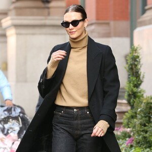 karlie-kloss-in-a-tan-turtleneck-black-jeans-and-black-overcoat-in-nyc-12-08-2023-1.jpg