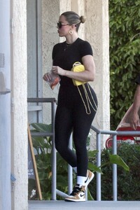khloe-kardashian-in-a-black-matching-outfit-with-a-yellow-mini-chanel-backpack-and-nike-sneakers-in-los-angeles-01-05-2024-1.jpg