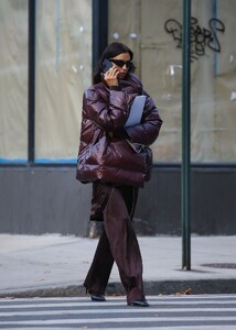 irina-shayk-in-a-plum-colored-puffer-coat-dark-brown-pants-and-sleek-black-boots-out-in-new-york-10-28-2024-0.jpg