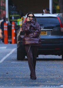 irina-shayk-in-a-plum-colored-puffer-coat-dark-brown-pants-and-sleek-black-boots-out-in-new-york-10-28-2024-3.jpg